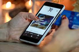 woman holding phone and card